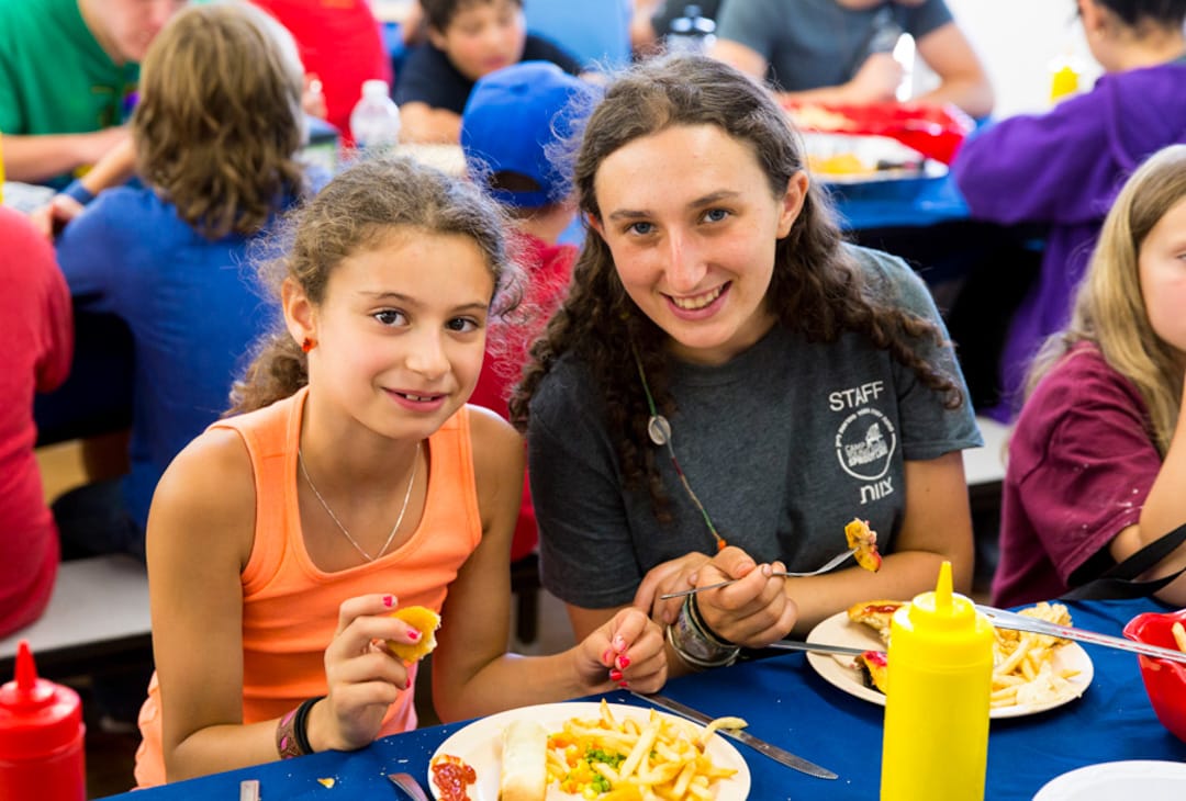 Westchester girl camper and female staff at lunch